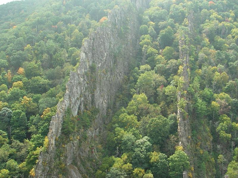 nelson-via-48.JPG - The two southern fins of Tuscarora sandstone. This area started as a sea floor.  230 million years ago the rock layers were lifted 90 degrees from horizontal to vertical.  Over time erosion wore away at the softer rock to leave what we see today.